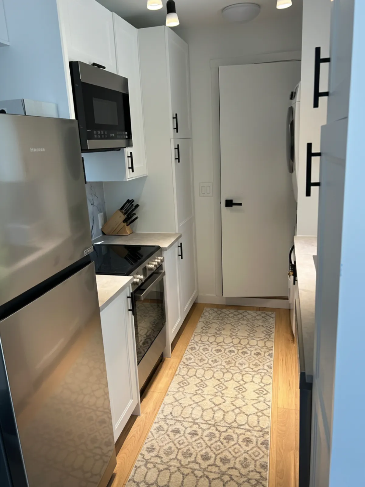 Modern kitchen interior inside a NED Living modular home, featuring full-size appliances and custom cabinetry