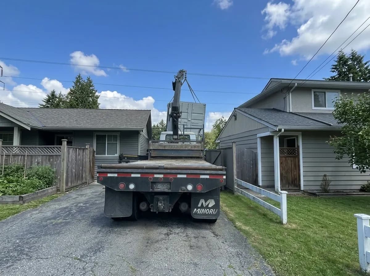 Modular office being delivered by crane truck to a residential property in BC by NED Structures