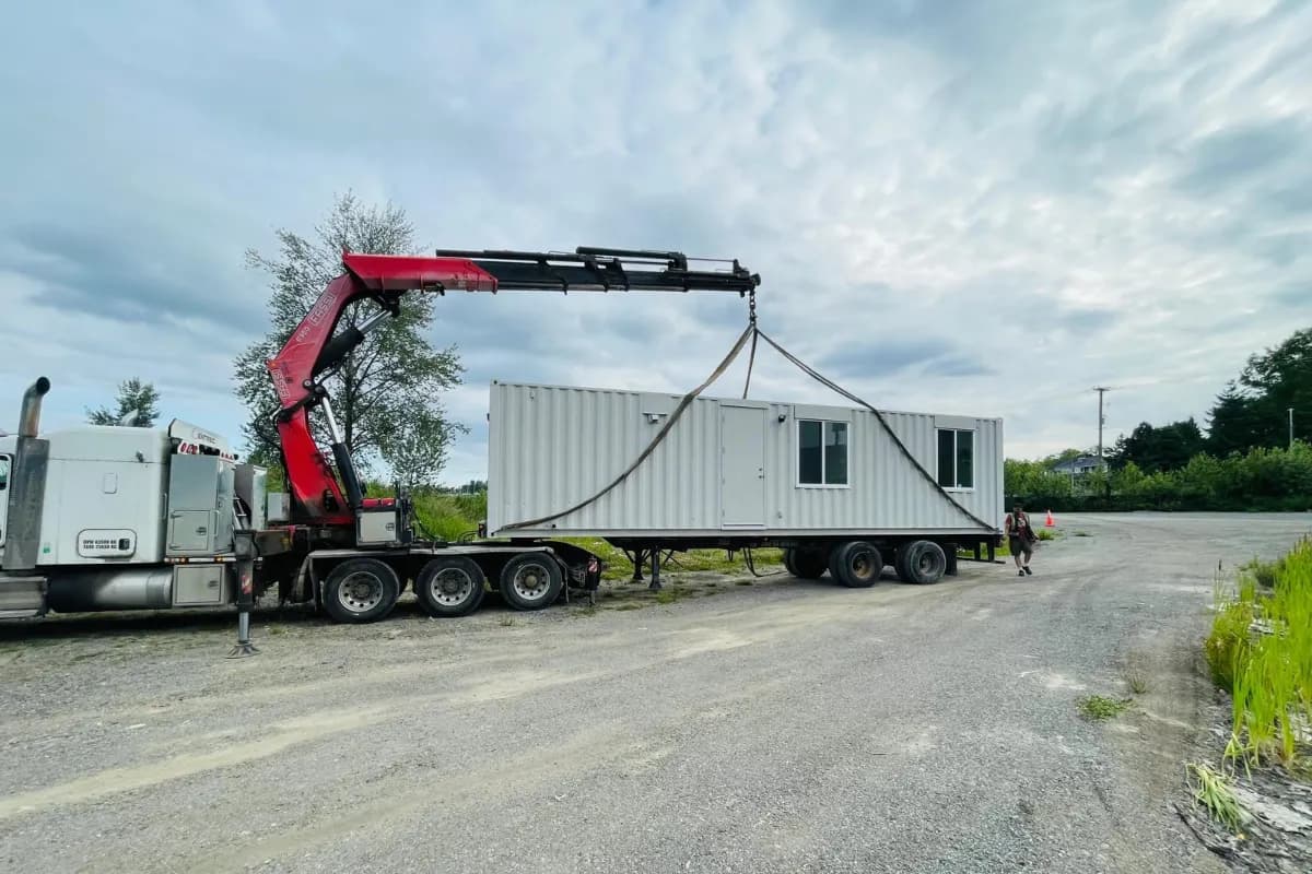 Modular site office unit being lifted into position by crane — NED Structures installation in BC
